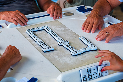 A stock photo of a zoomed in view of a game of dominos.
